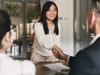 A woman shaking a mans hand