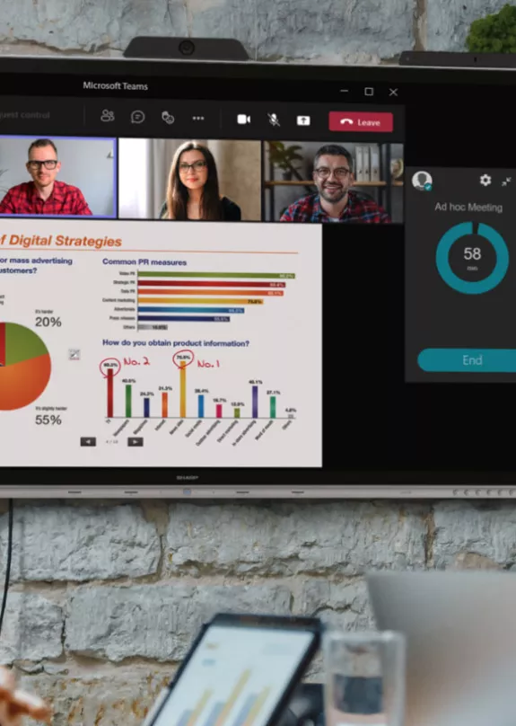 Man presenting at small workgroup hybrid meeting